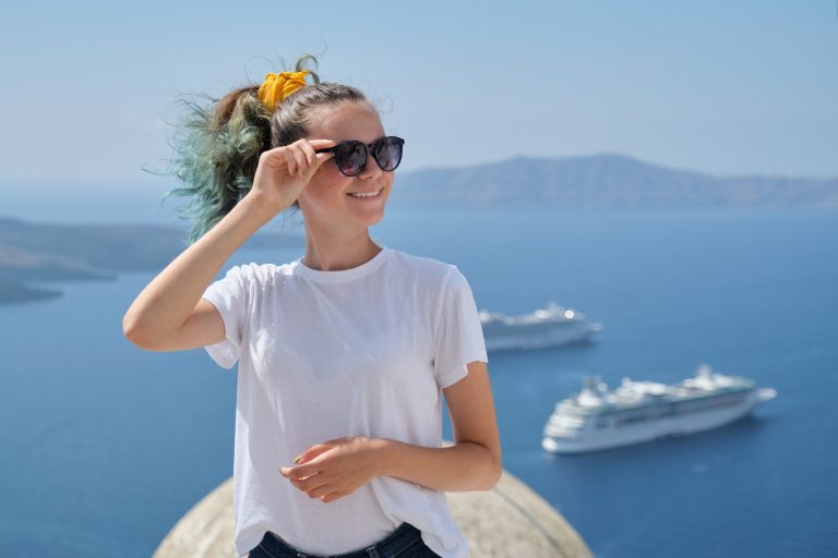 Young girl tourist smiling, background scenic sea landscape with cruise liners