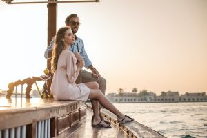 Romantic couple watching from boat at Dubai marina, United Arab Emirates